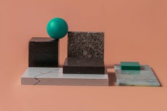 Causality-Aware 2D Materials Benchmark for Economics & Policy