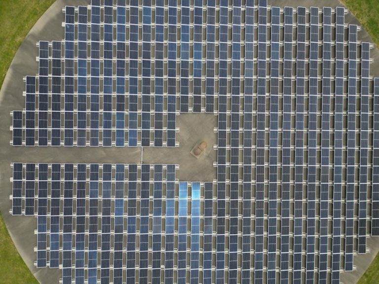 Aerial view of large solar panel array generating renewable energy.