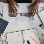 Architecting Autonomous Supply Chain Resilience: A Guide Architect analyzing blueprints and sketches at a modern workspace.