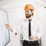 <h1>Architecting Explainable Emergent Behavior Platforms for Next-Generation Space Systems</h1> Professional engineer explains blueprint on digital screen in modern office.