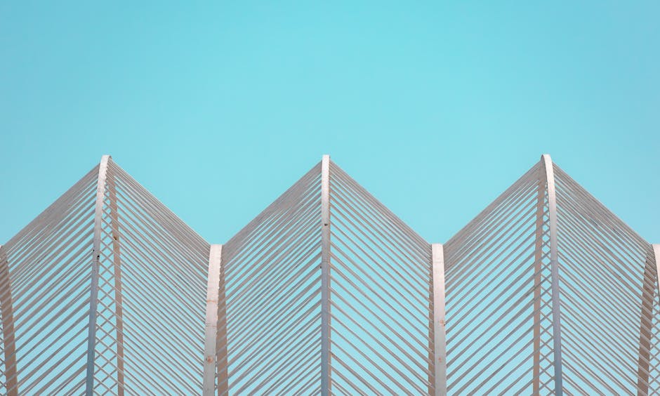 Contemporary geometric architectural structure set against a clear blue sky in Valencia.