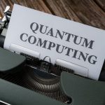 Quantum computing concept displayed on a vintage typewriter on wooden table.