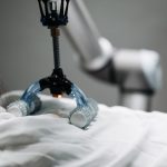 Automating Wellness: Engineering High Performance Systems Close-up of a robotic massage arm applying therapy on a person, showcasing innovation.