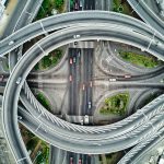 Autonomous Intent-Centric Networking for Supply Chain Aerial view of a modern highway interchange in Abidjan, showcasing intricate road design.