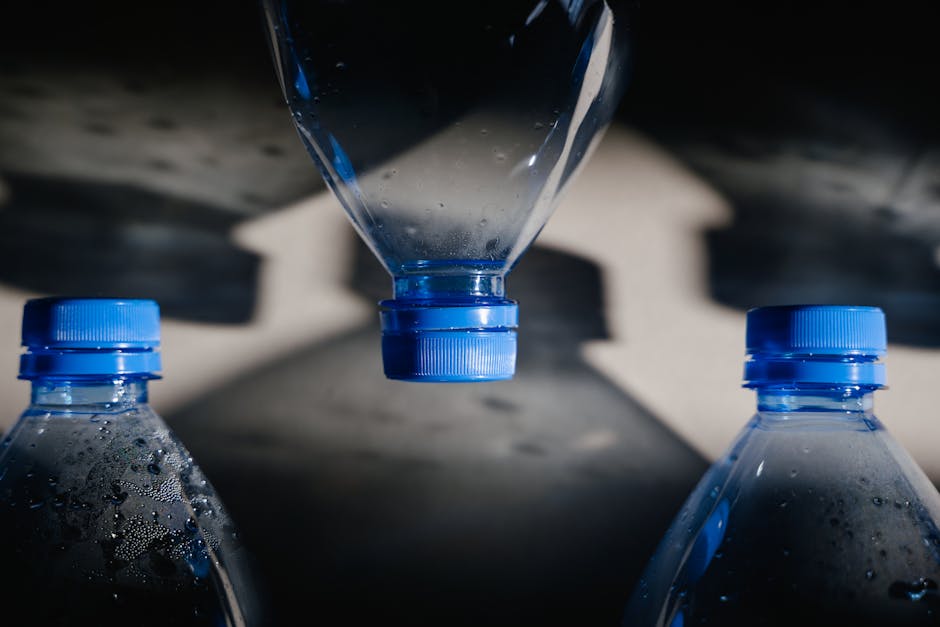 Artistic close-up of plastic bottles casting intricate shadows on a surface.