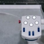 Detailed view of a modern industrial control panel with illuminated buttons and switches.