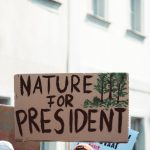 Biodiversity as Political Strategy: Managing Complexity for Leaders Sign at a climate protest advocating for environmental priorities with text 'Nature for President.'