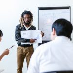 Business team discussing cryptocurrency and blockchain strategies in an office setting with a focus on financial growth.