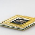 A detailed close-up of a CPU microchip showcasing its intricate gold pins and technology.