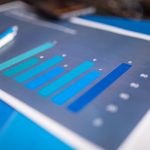 Detailed close-up of a blue bar graph showing data analysis on printed paper.