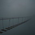 <h1>Bridging the Gap: An Uncertainty-Quantified Soft Robotics Framework for EdTech</h1> Spooky suspension bridge vanishing into a dense fog, creating a mysterious atmosphere.