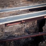 Aerial view of highway bridges spanning a rugged rocky canyon in the United States.