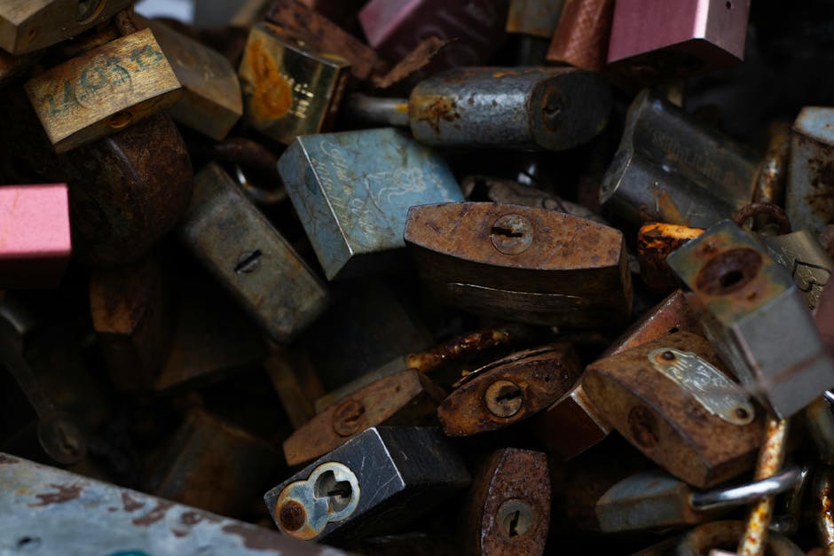 A collection of old, rusty padlocks attached to a metal surface, symbolizing nostalgia and security.
