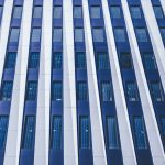Building a Scalable Hospital at Home EdTech Framework Guide Full frame facade of contemporary multistory building with windows and decorative white panels located on street in financial district of city