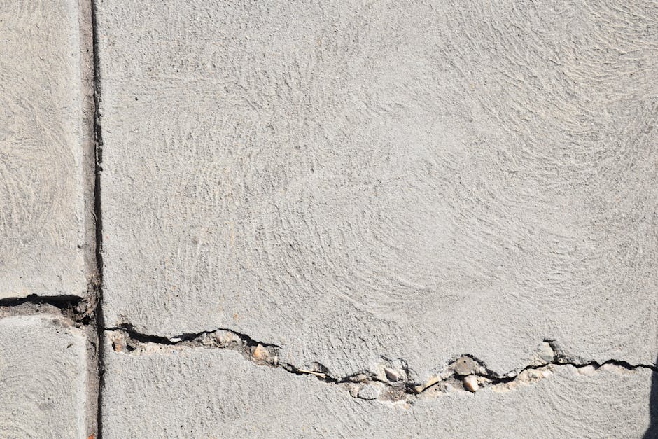 Close-up view of a cracked concrete surface with distinct textures in Logan, Utah.
