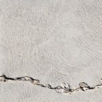 Building Fault-Tolerant Toolchains for Autonomous Vehicles Close-up view of a cracked concrete surface with distinct textures in Logan, Utah.