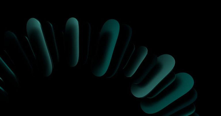 A striking abstract image with dark teal shapes forming a circular pattern on a black background.