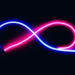 Vibrant neon infinity symbol glowing in blue and pink against a dark backdrop, evoking endless possibilities.