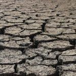 Climate Risk: A Strategic Framework for Operational Resilience Aerial view of cracked, dry ground representing drought and environmental stress.