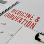Cloud-Native Bioelectronic Medicine: Engineering Future Therapy Close-up of 'Medicine & Innovation' paper with pills and documents on a desk.