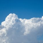 Cloud-Native Climate Adaptation: Engineering Resilient Models Bright white cumulus clouds floating in a clear blue sky on a sunny day.