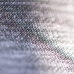 Cloud-Native Nanofabrication: Scaling Biotech Protocols Closeup of fragment of abstract fabric sewn from thin grey threads against blurred background