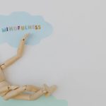 <h1>Cloud-Native Theory of Mind: Engineering Empathy and Cognition in Biotech AI</h1> Wooden mannequin with mindfulness text on light blue cloud background, conveying calm.