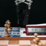 <h1>Competitive Soft Robotics Algorithms: The Future of Precision Agritech</h1> Robotic arm moves chess pieces on a board with electronic digital timer displayed.