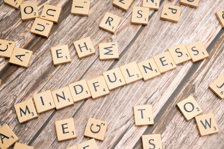 Wooden letter tiles spelling 'mindfulness' on a rustic wood background.