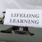 Continual Learning and Intent-Centric Health Networks Close-up of a vintage typewriter displaying 'Lifelong Learning' on paper.