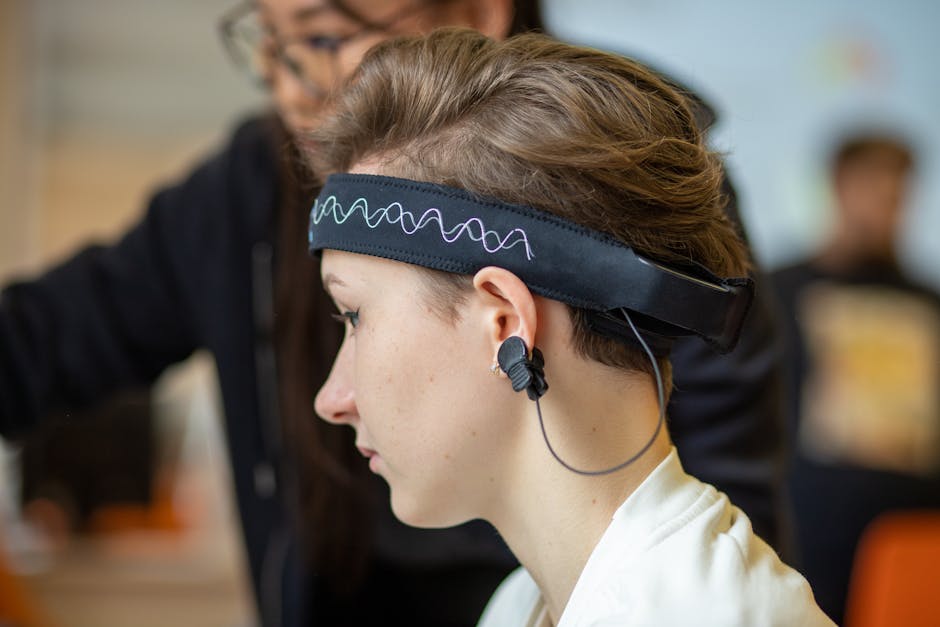 Close-up of a young woman wearing an EEG headband, showcasing modern technology indoors.