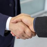 <h1>Cooperative Causal Inference: The Next Frontier for Edge and IoT Intelligence</h1> Close-up of two business professionals shaking hands, symbolizing partnership and collaboration.