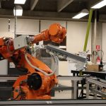 Cooperative Cellular Robotics: Benchmarking Edge Performance Industrial robotic arm in a Ciudad de México lab setting, showcasing automation technology.