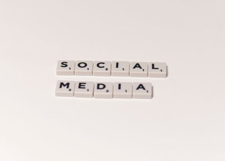 Scrabble tiles spelling 'social media' on a white background, representing digital communication concepts.