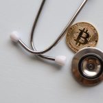 Crypto in Healthcare: Strategic Realities for Future-Ready Leaders A stethoscope with a Bitcoin coin symbolizing the intersection of healthcare and cryptocurrency.