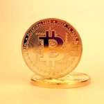 Decentralized Digital Twins in Collaborative Neuroscience A close-up of a golden Bitcoin highlighting its digital currency design.