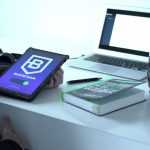 Decentralized Identity in EdTech: Secure Academic Credentials A desk with tablet displaying blockchain, laptop, book, and camera lens, symbolizing tech and innovation.