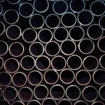 A detailed macro shot of stacked metal tubes forming a circular pattern, highlighting industrial design.