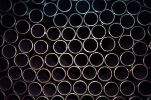 A detailed macro shot of stacked metal tubes forming a circular pattern, highlighting industrial design.