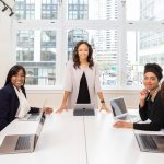 Digital Exile: Why Leaders are Retreating to Nature to Build Strategy Multicultural team collaborating in boardroom with laptops, showcasing teamwork and diversity.