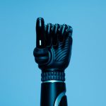 Edge-Native Bioelectronics and Programmable Biology Close-up of a prosthetic arm in a vibrant blue setting, showcasing advanced technology.