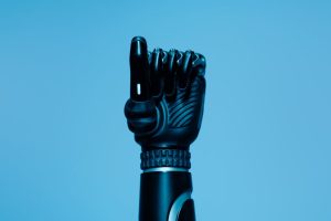 Close-up of a prosthetic arm in a vibrant blue setting, showcasing advanced technology.