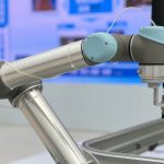 Detailed close-up of a modern industrial robotic arm in a manufacturing setting.