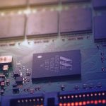 Energy-Aware Nano-Fabrication for XR Hardware Detailed image of an electronic circuit board showing microchips and intricate wiring in a modern technological setting.