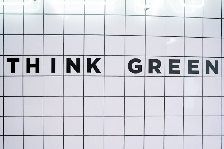 Modern wall art featuring the inspiring text 'Think Green' on a tiled background.