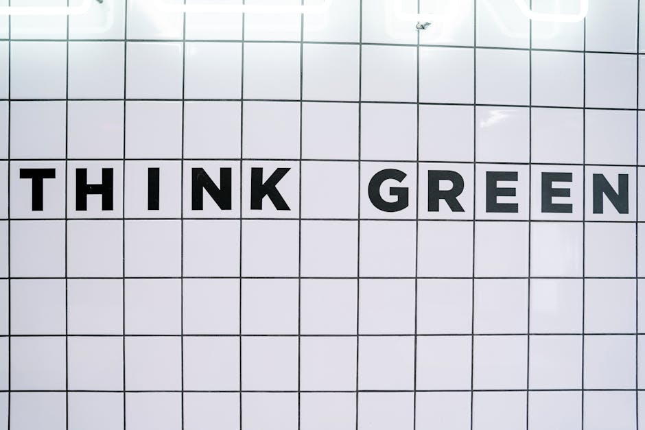 Modern wall art featuring the inspiring text 'Think Green' on a tiled background.