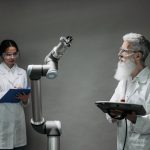 Two scientists working with a robotic arm in a lab setting, focusing on innovation and technology.