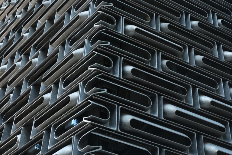 Intricate modern architectural facade with geometric metal patterns capturing urban design.