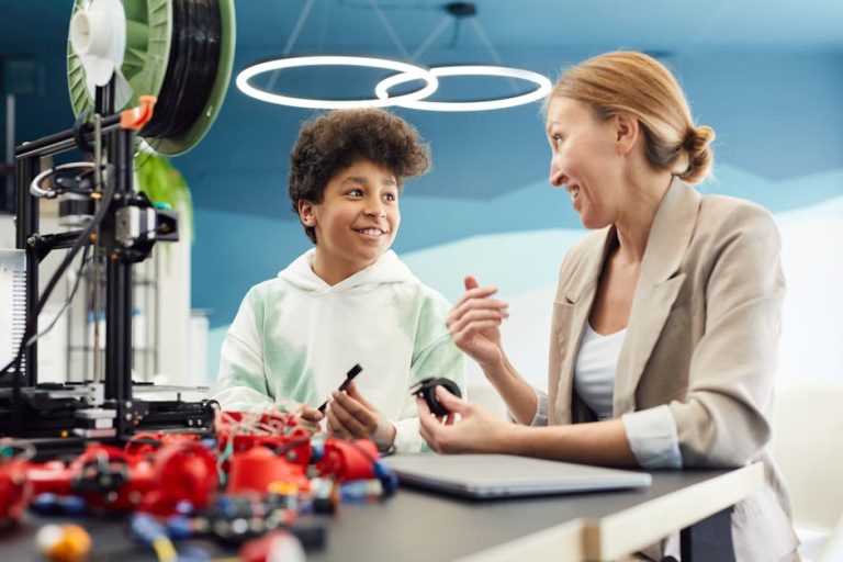 Smiling young male engineer sitting at table with woman and discuss project together while looking at each other in light room