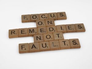 Scrabble tiles spelling an inspirational message on focus and problem-solving.